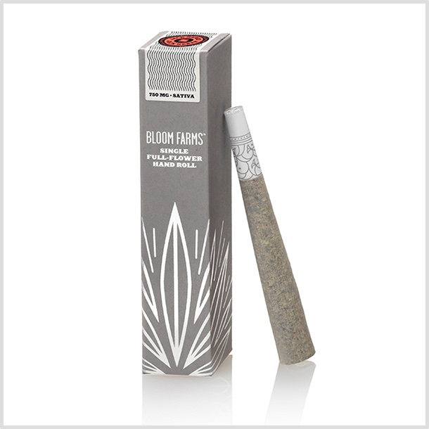 A pre-roll leaning on custom packaging. The crutch has a pattern design that spirals around the filter