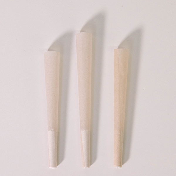 three certified organic 100% hemp pre-rolled cones lying on a white background