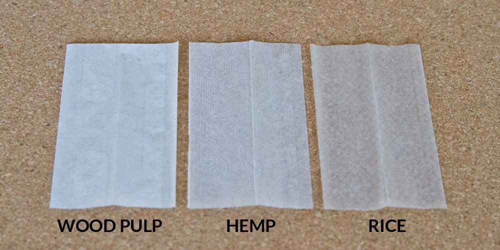 Three sheets of paper lying next to each other in the order of flax, hemp, and rice paper