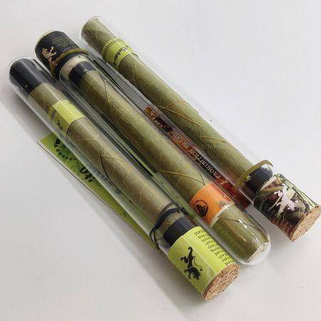 A pile of palm leaf blunt wraps inside Prohibition branded glass tubes